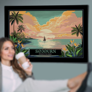 A framed travel-style art print hangs on a wall in a room, showing a tropical sunset seascape with palm trees, clouds, a sailboat, and the text 'SOJOURN' and 'Find Beauty in the Journey.' A blurred person is visible in the foreground holding a cup, but the main sold item is the framed print/poster rather than the person or room decor.